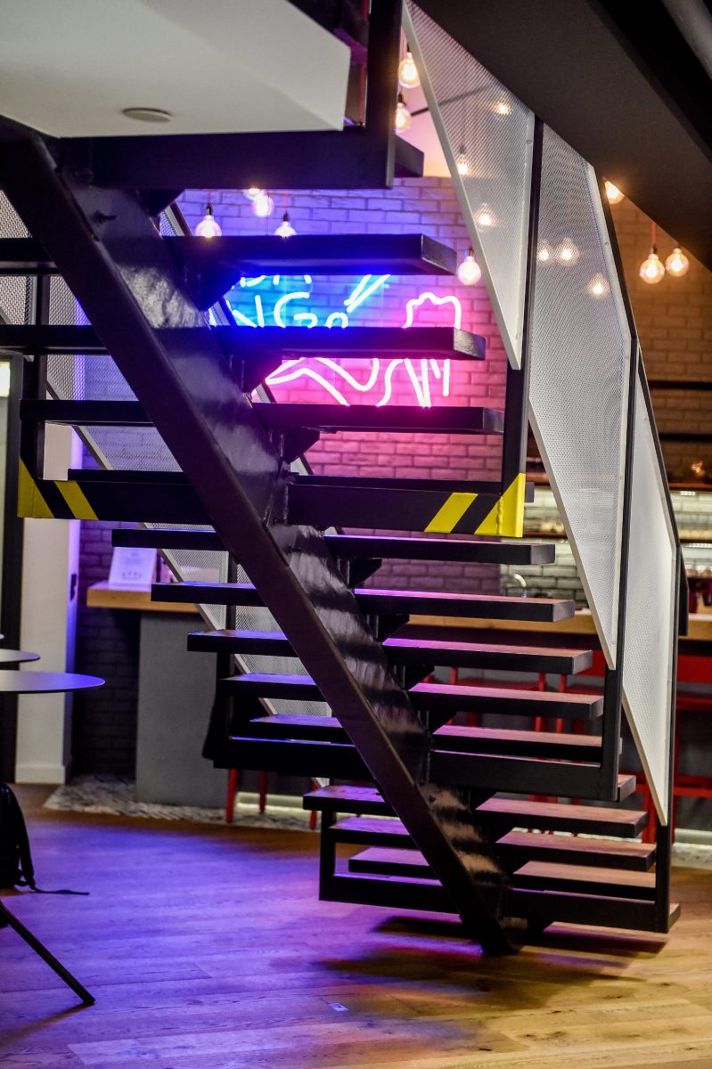 Industrial staircase, balustrade and neon sign in Studio HBO Poland
